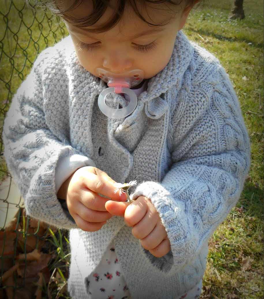 child with a dandelion in his hands