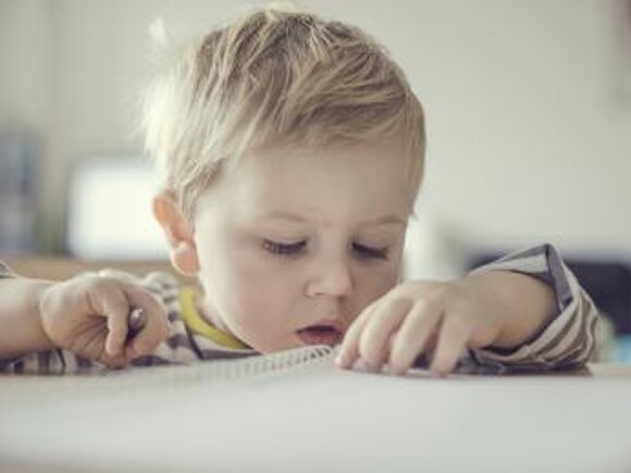Baby boy exploring notebook