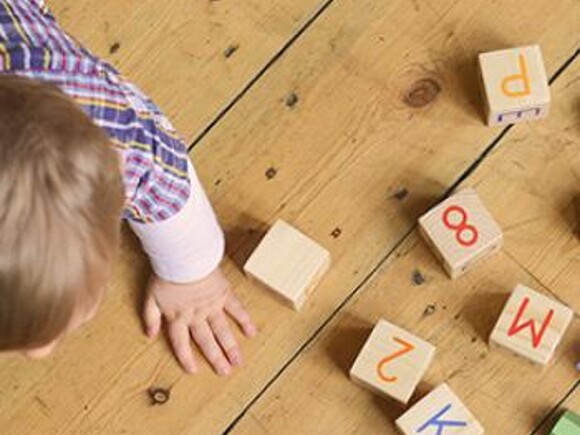 Baby playing with alphabet cubes