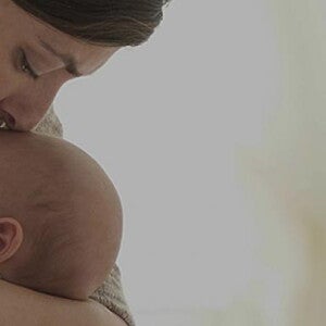 Mom kissing her baby