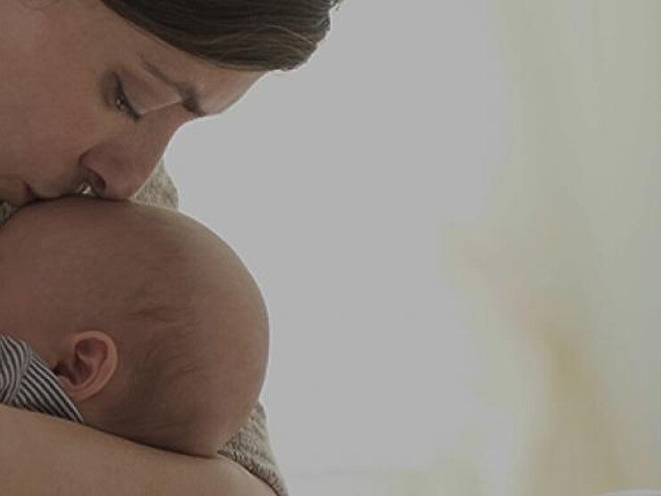 Mom kissing her baby