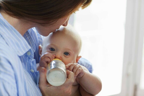 baby eating on hands