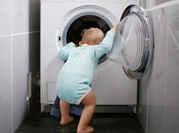 Baby exploring washing machine