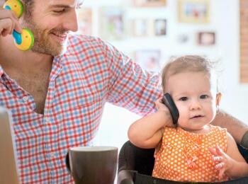 Baby and dad playing with phones