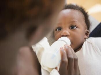 Mom bottle feeding baby