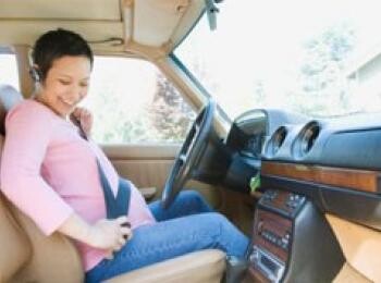 Pregnant woman wearing seat belt