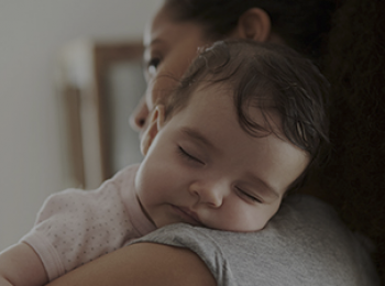 Mom holding sleeping baby